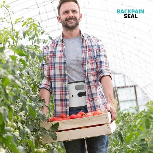 Man working in a vegetable garden wearing a Spinal Decompression Belt for back pain issues